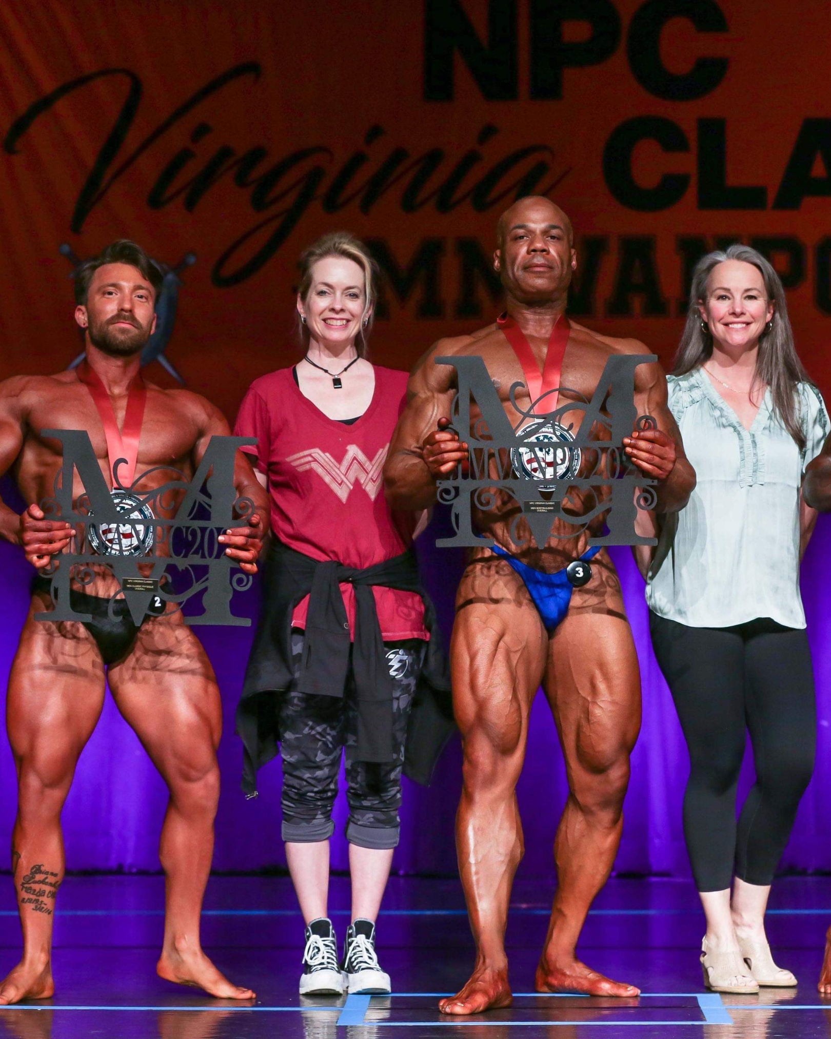 Corry and Stacia with overall bodybuilding winners - 2 males